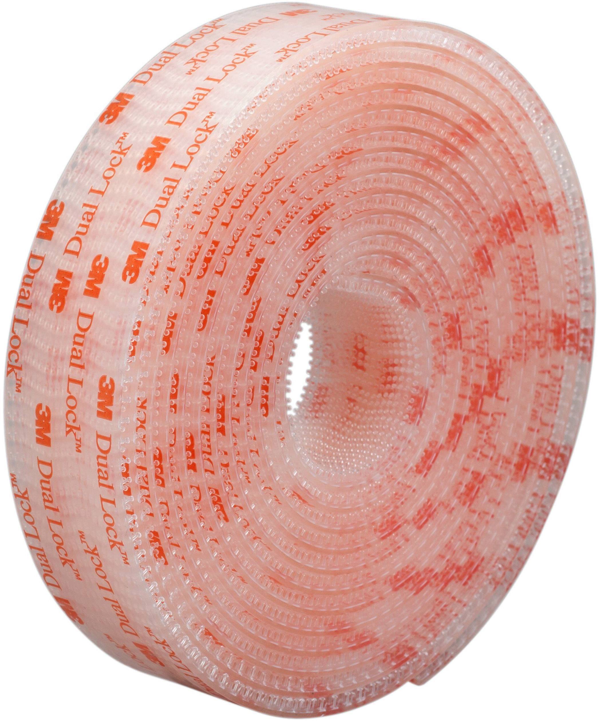 A roll of 3M 'Dual Lock' hook-and-loop fastener, transparent with red text, viewed from the side. The tape has small mushroom-shaped hooks without an adhesive side.