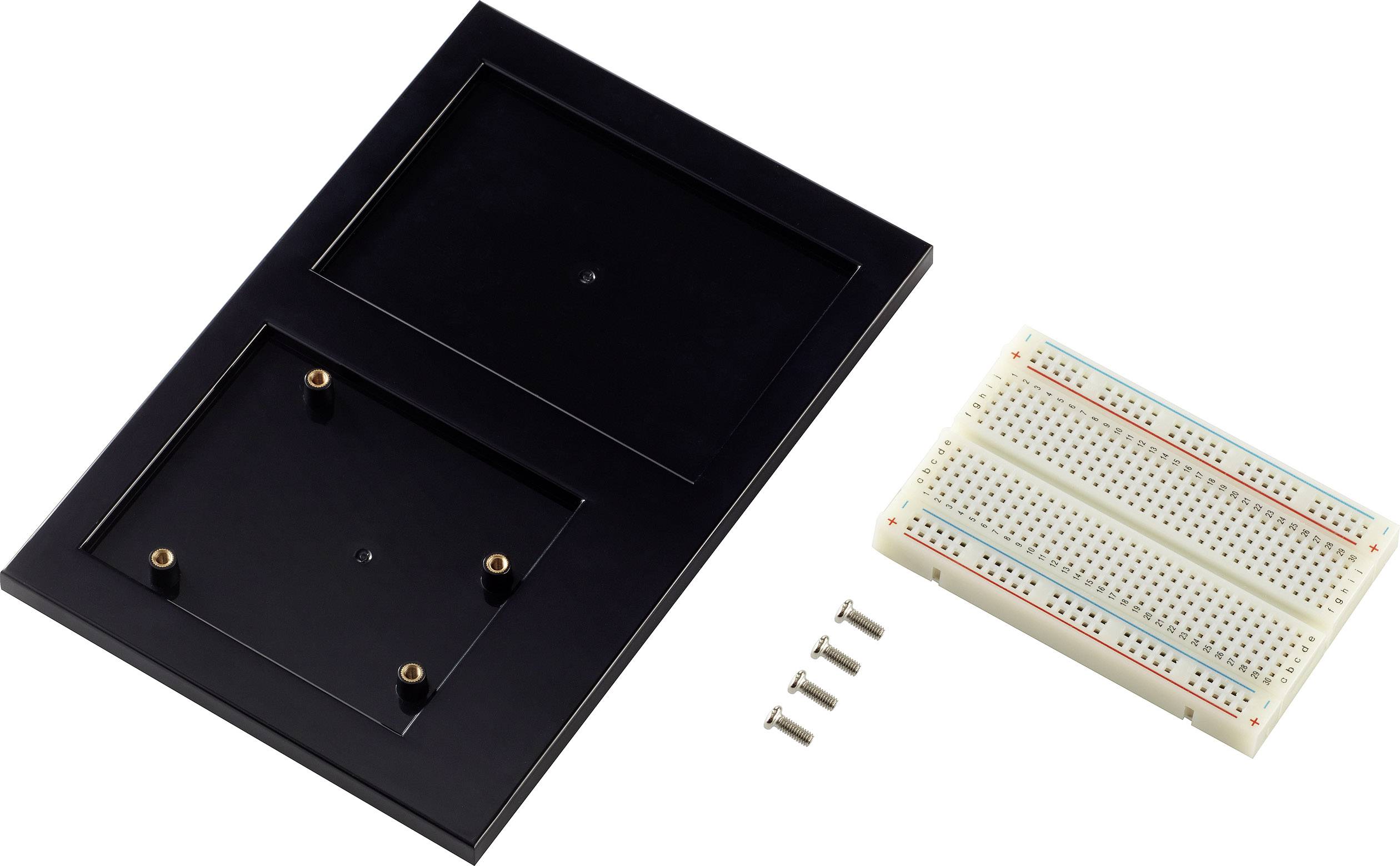 Black plastic plate with two rectangular recesses, alongside a circuit board and four small screws.