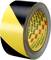A roll of black and yellow marking tape with visible 3M logo, used for safety marking or demarcation.