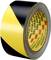 A roll of barrier tape with black and yellow stripes for safety markings.