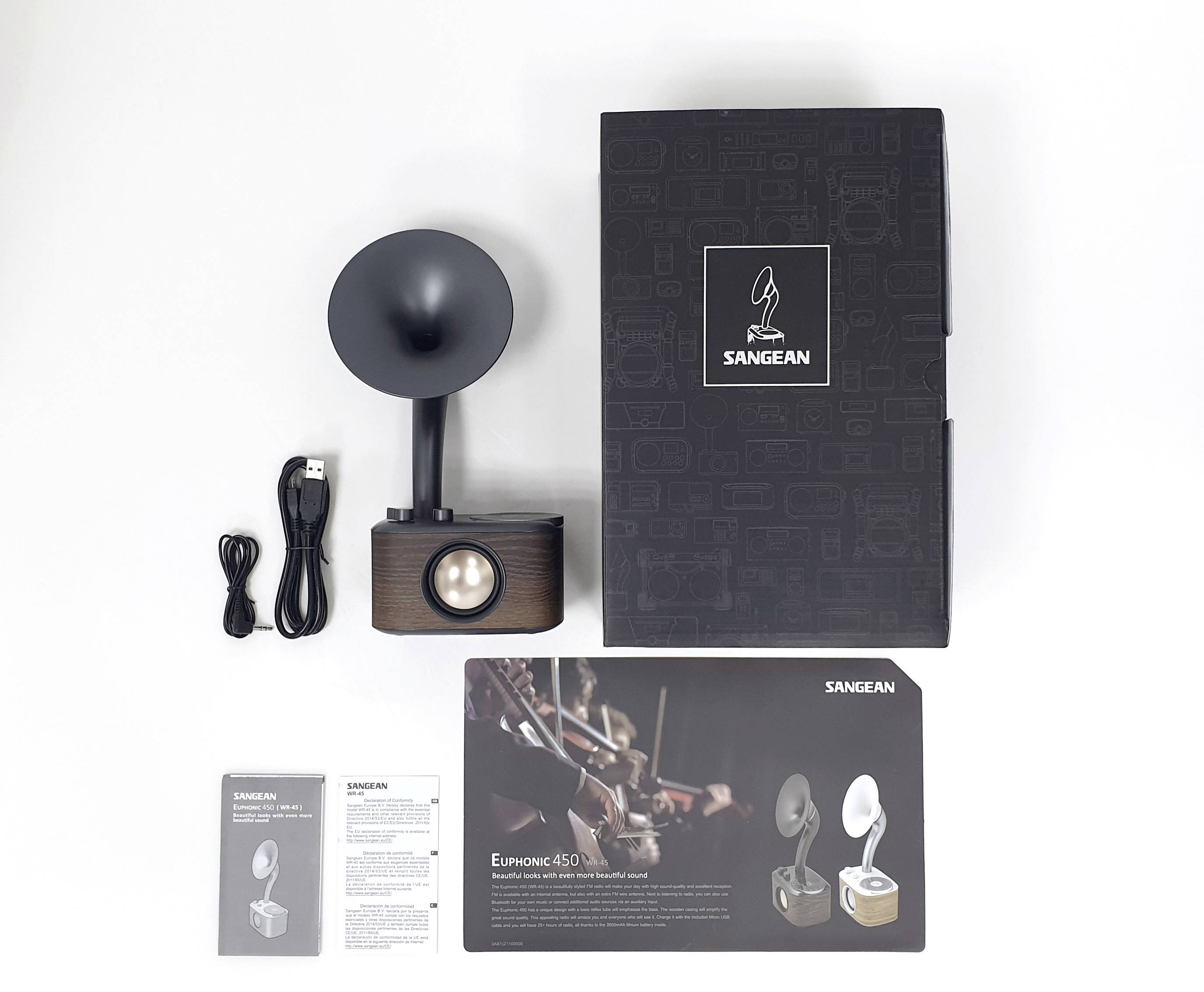A retro design radio with speaker, USB cable, instruction manual and product description. Packaging with Sangean logo.