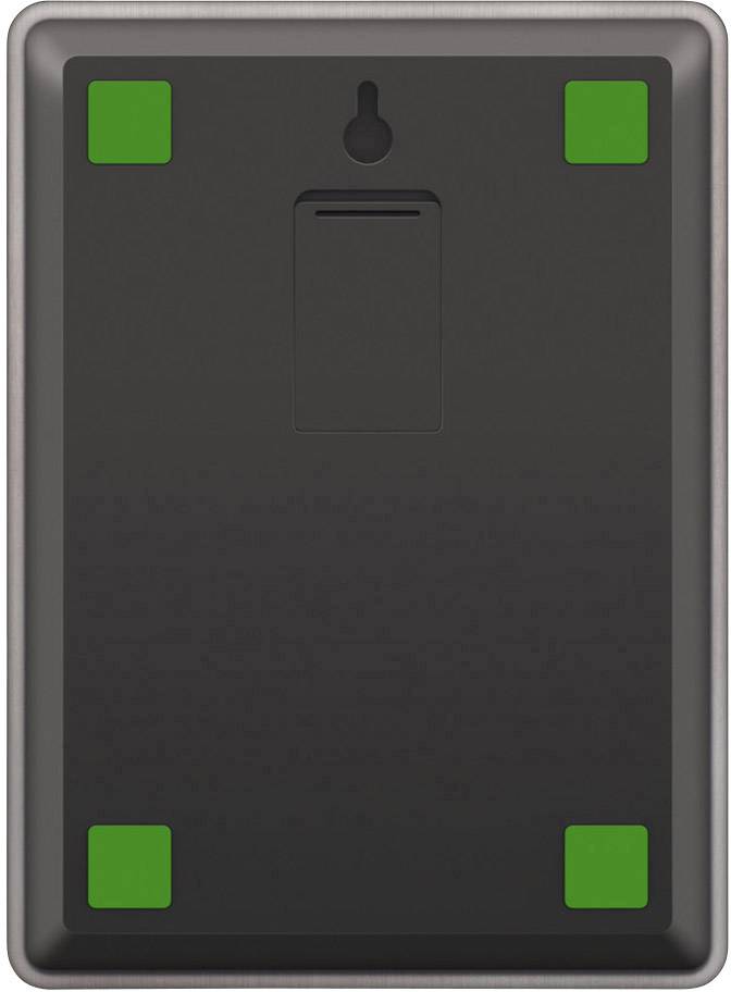 A rectangular object with four green squares at its corners, placed on a black surface.