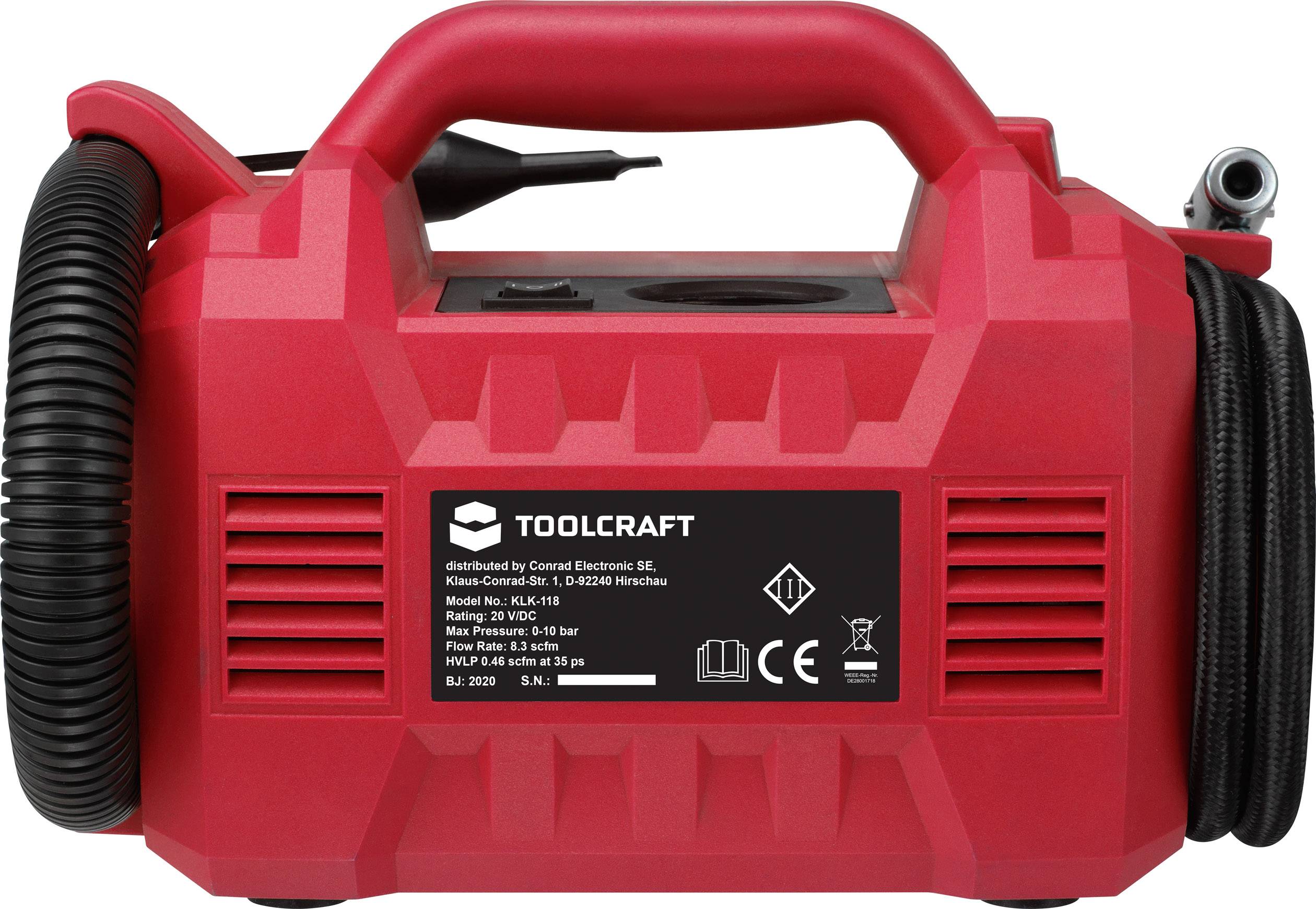 Red compressor with carrying handle and black spiral hose. Label with specifications shows Toolcraft brand and technical details.
