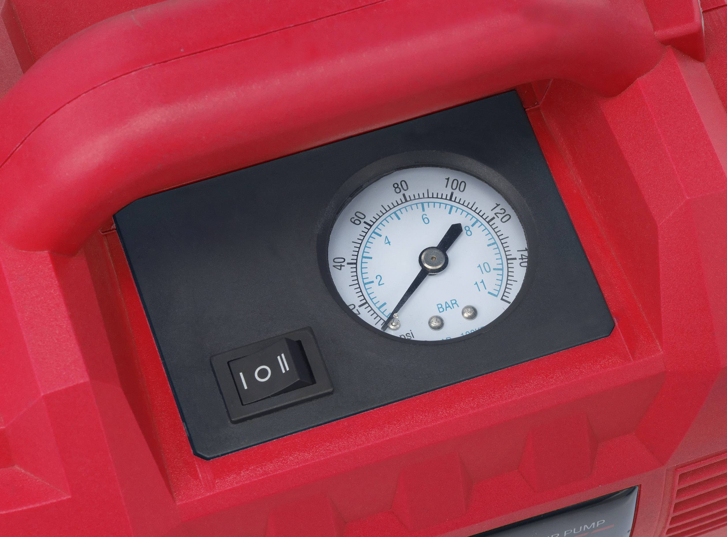 A red device with a pressure gauge in bar. It also has a toggle switch.