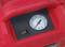 A red device with a pressure gauge in bar. It also has a toggle switch.