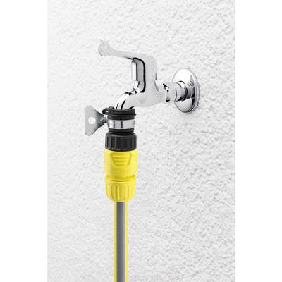 A silver tap on a white wall, fitted with a yellow hose adapter.