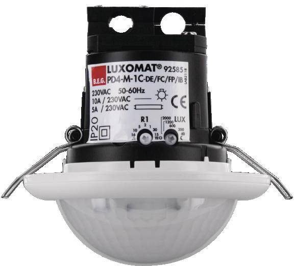 A LUXOMAT motion sensor with technical specifications on label: 230VAC, 50-60Hz, 5A. Ceiling-mounted design.