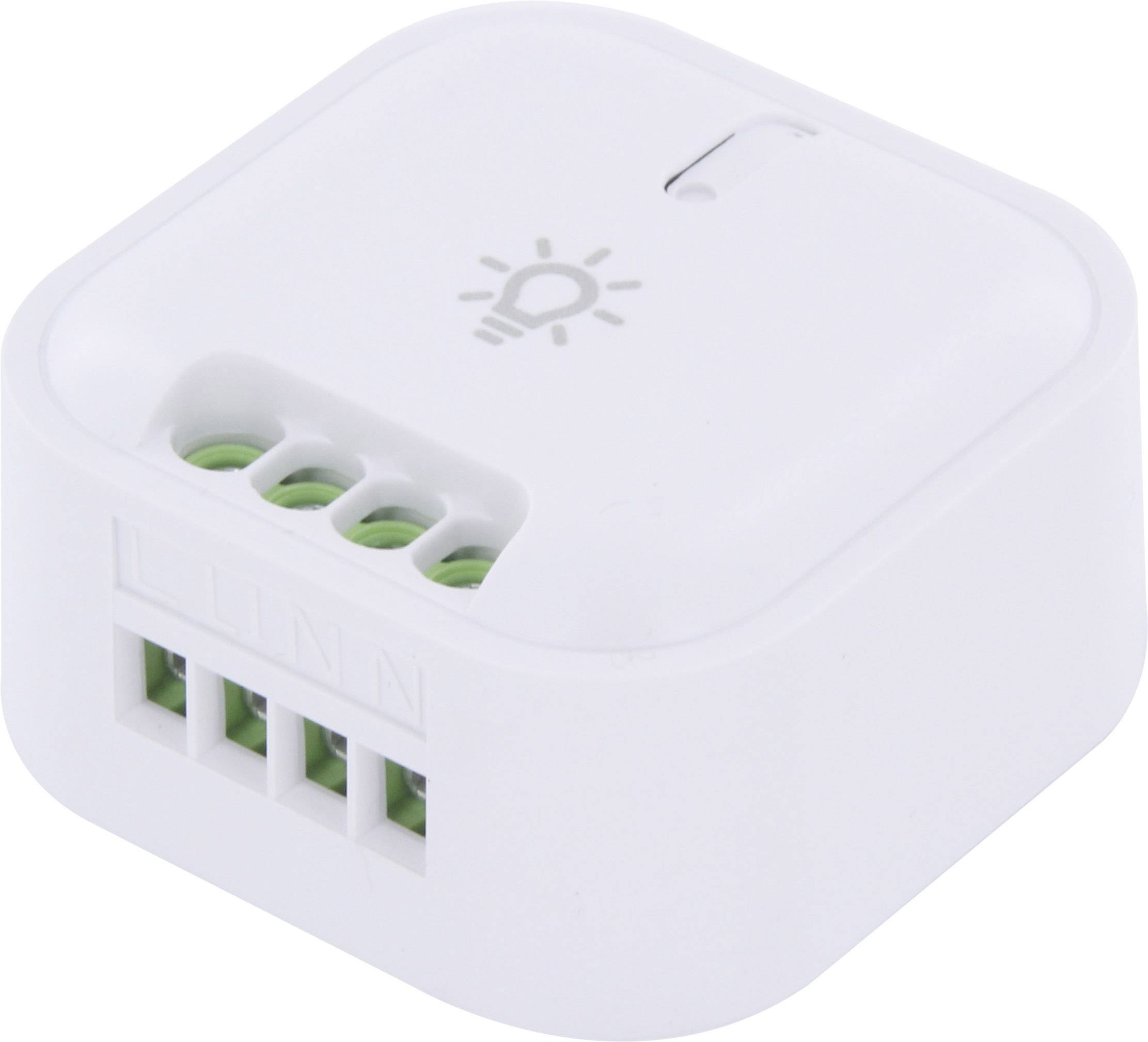 Small white square switch with a small lamp symbol at the top, several green connection terminals on the side. Housing with no visible brand markings.