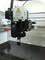 3D printer with warning sign 'Caution: Hot!/Caution high temperature'. Close-up of the print head during operation.