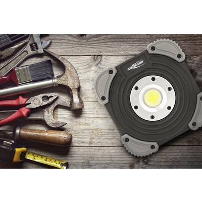 Tools on a wooden surface: hammer, screwdriver, pliers, paintbrush and tape measure. A work light on the right.<br><br>Note: The translation is already in British English, so no significant changes were needed.
