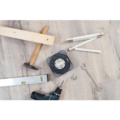 'Construction tools on wooden floor: piece of wood, hammer, ruler, spanner, spirit level, drill and screws.'