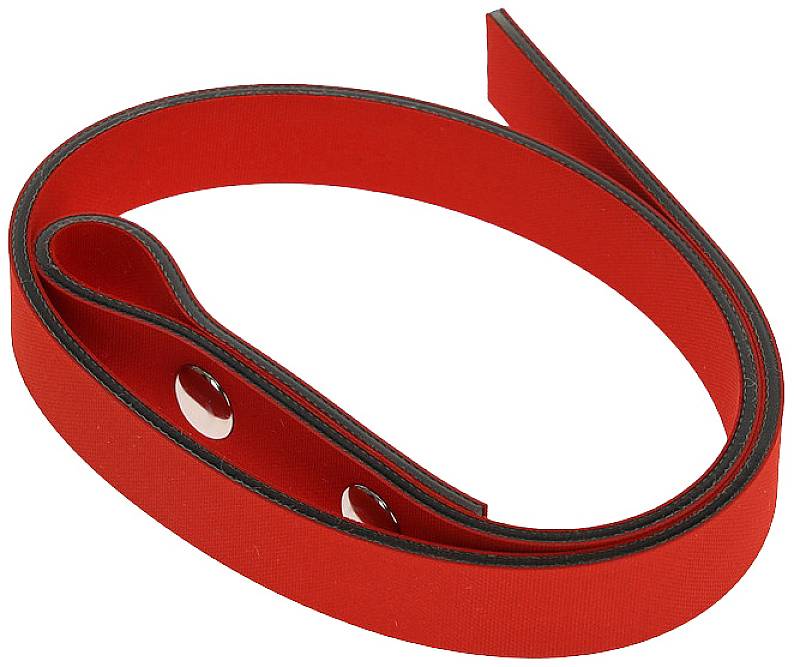 A long, red belt with black edges and holes, rolled up on a white surface.
