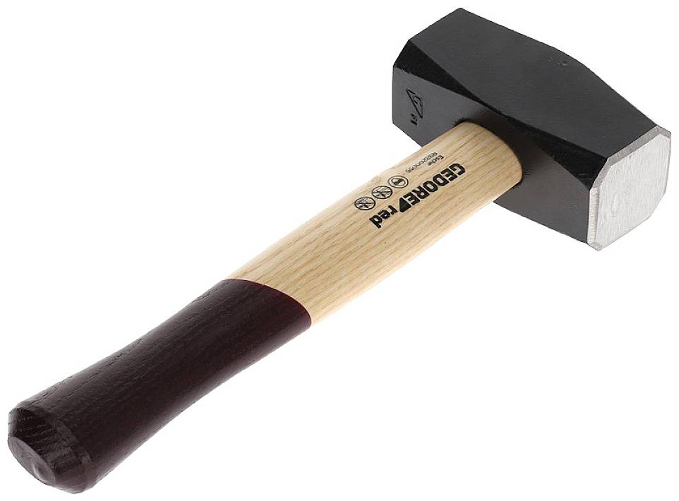 A hammer with a wooden handle and a black metal head is lying on a surface.