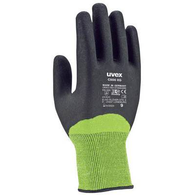 A black work glove with a green wrist in close-up. Printing shows CE mark and manufacturing details.