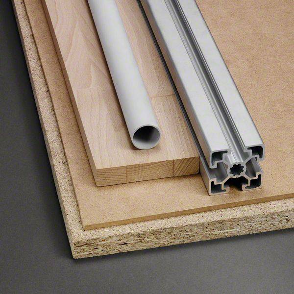 Metal profile with four chambers on wooden, plastic, and cardboard panels. Mechanical connecting materials in neutral colours.