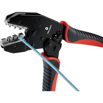 A crimping pliers with rubber grips in red and black. A blue cable is placed between the jaws, ready to be crimped.