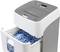 Paper shredder with pulled-out container, filled with blue paper shreds. Electronic control panel visible on top.