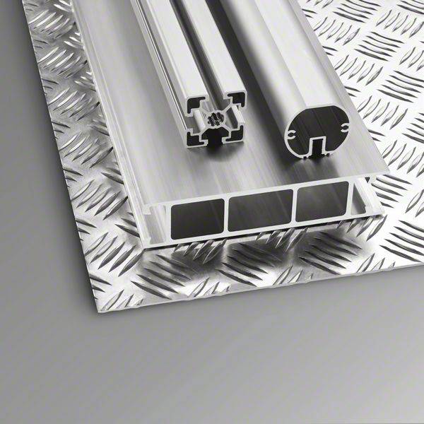 Aluminium profiles on a corrugated metal sheet. Various cross-sections: rectangular with hollow spaces and a round profile with open sides.