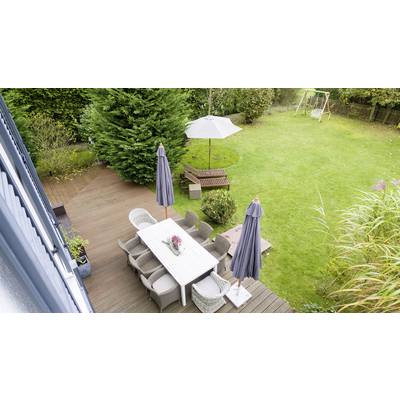 Garden with a lawn, patio, table with chairs, parasols, wooden benches, and swings in the background.