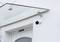 Above a front door with a glass canopy, a surveillance camera is mounted on the white wall.