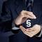 A man in a suit carefully holds a floating paragraph symbol between his hands, symbolising legal matters.