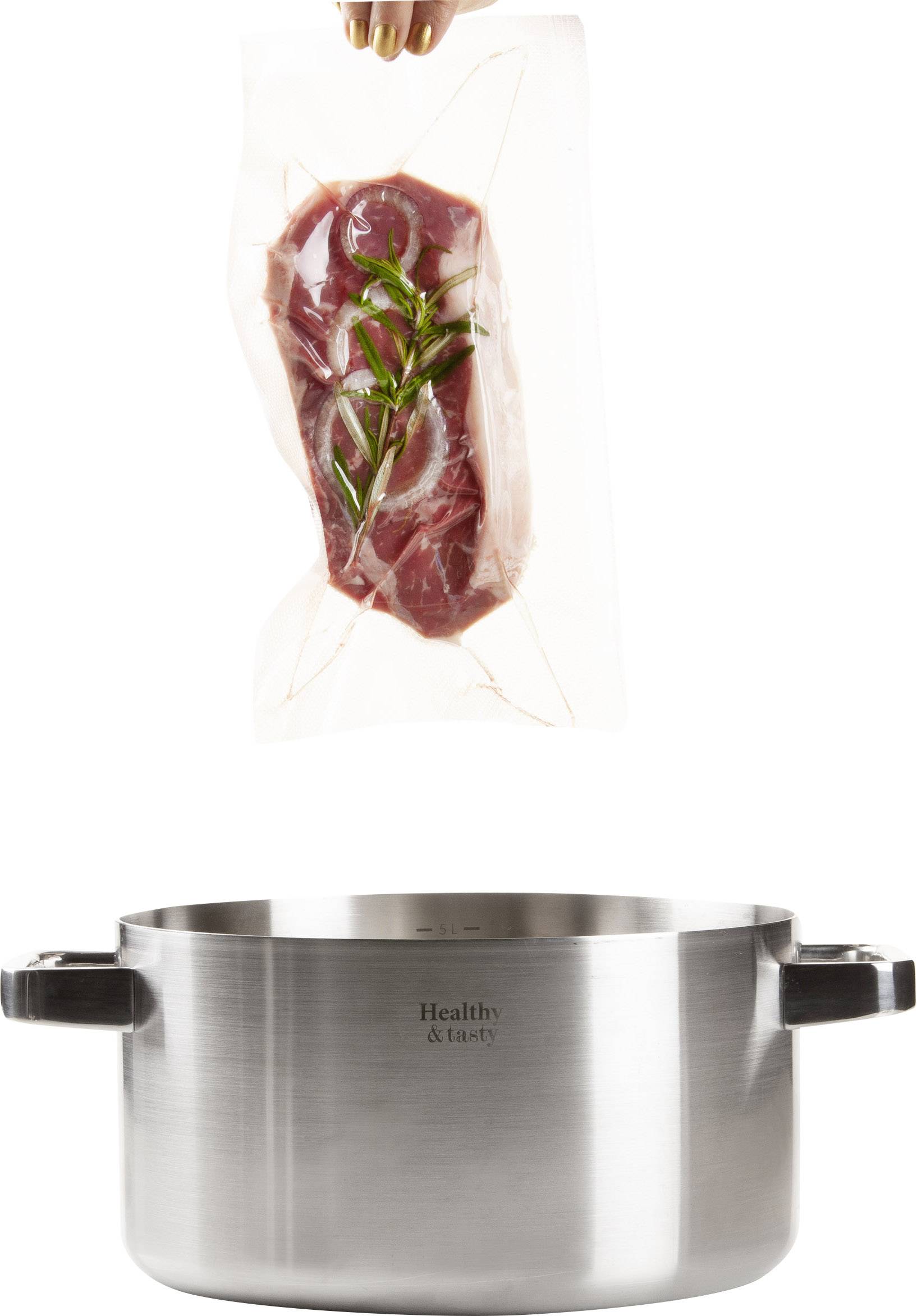 A hand holds a vacuum-packed steak with rosemary above a cooking pot.
