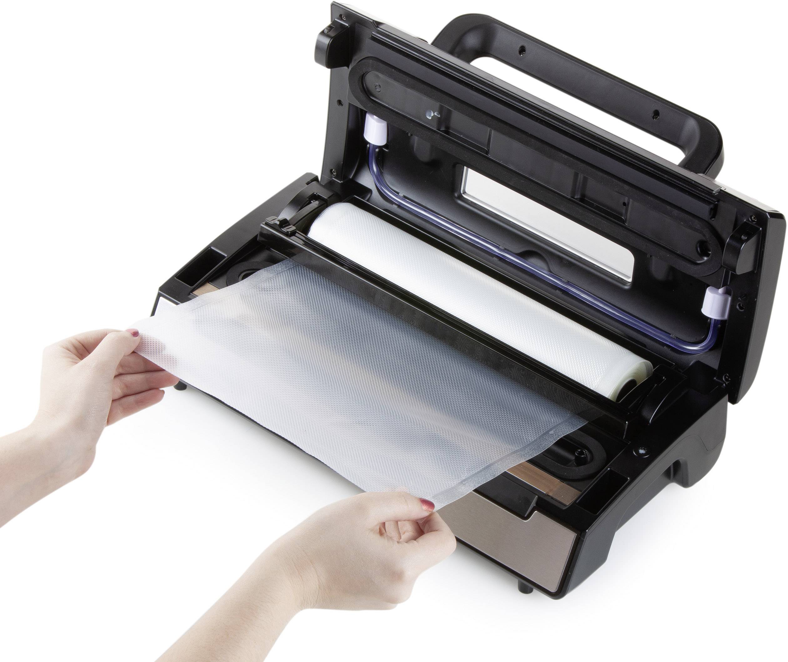 A person is placing a plastic bag into a vacuum sealer. The device is open and ready to seal food items.