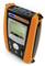 A portable measuring device in orange and black with a digital display, showing a graphical curve and multiple connectors on top.