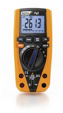Digital multimeter with an orange casing, displaying '26.13' on the screen. Control knob, various buttons and sockets visible.