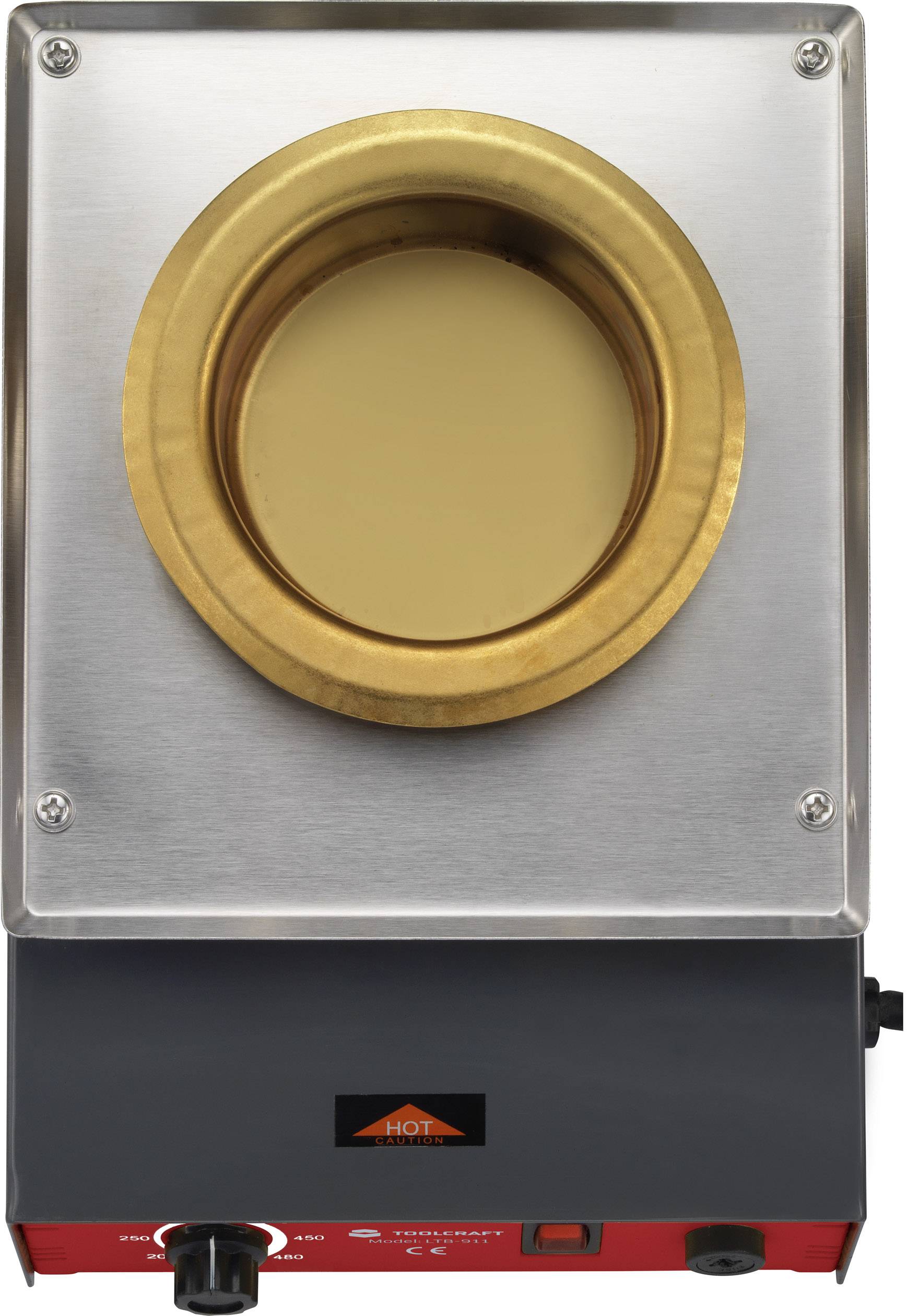 Hot air oven with gold-coloured opening, metal casing and red control element. 'HOT' note on front panel.