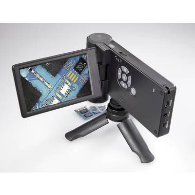 A handheld microscope on a small stand displays an enlarged view of an electronic circuit with pins on its screen.
