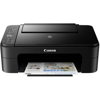 A black Canon printer is printing a document with images and text. The control panel is located in the top left corner.