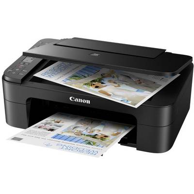 A black Canon printer is printing a colourful photo of people. The printer is situated on a white surface.
