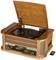 A vintage wooden record player with an open lid. A vinyl record is placed on the turntable. A small remote control lies beside it.