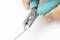 'Close-up of a hand using blue pliers to cut a thin wire.'