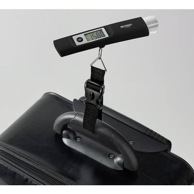 A digital luggage scale shows a weight of 15.80 kg while attached to a black suitcase handle.