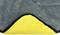 Grey towel made of soft material, with corner folded back, revealing a yellow inner lining.