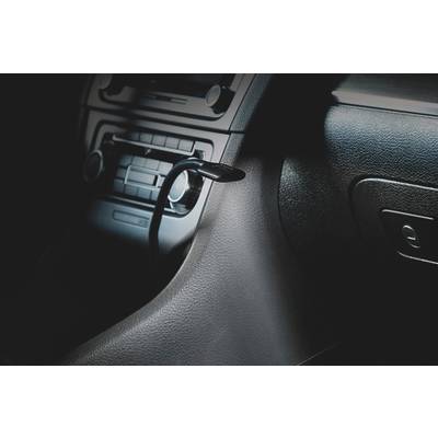Interior view of a car showing the gear stick and dashboard. Focus is on the vehicle instruments and control elements.