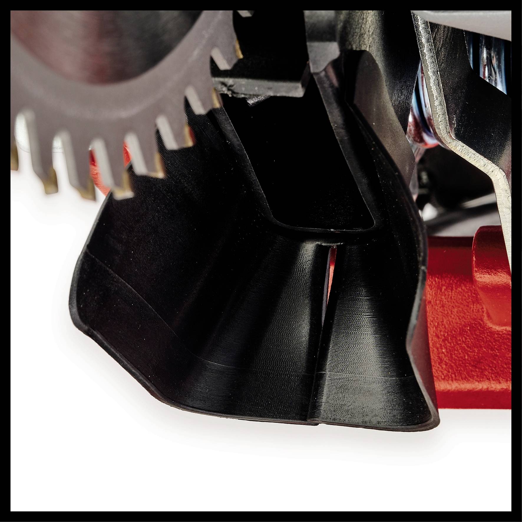 Close-up of a mechanical component with black vanes and a toothed metal disc. Technical details are visible.