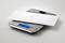 A white envelope lies on a digital scale. The display shows a weight of 12 grams.