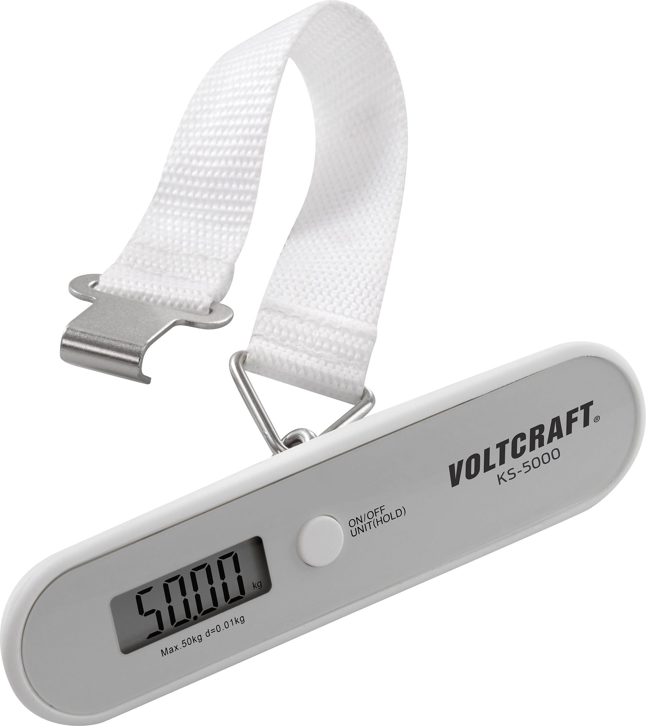 Digital luggage scales with digital display showing '5.000 kg'. White strap with metal hook, brand 'Voltcraft KS-5000'.