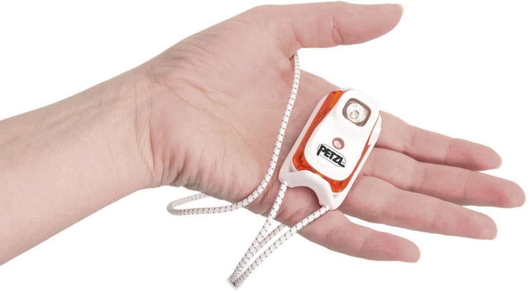 A hand is holding a small, white torch with a red accent and a ribbon. It is compact and portable.<br><br>Note: In British English, "torch" is used instead of the American "flashlight", maintaining the natural language while preserving the original meaning.