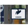 A sign with a camera symbol and the word 'VIDEO', indicating video surveillance. Blurred urban details are visible in the background.