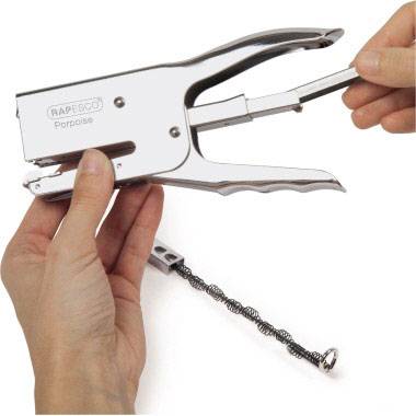 A person is holding a silver hole punch pliers and effectively deburring the punched holes. No text is present in the image.