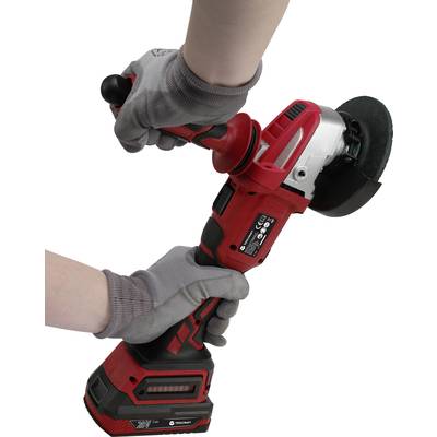 A person is holding a red angle grinder with both hands. The grinder is switched on and is being operated with protective gloves.