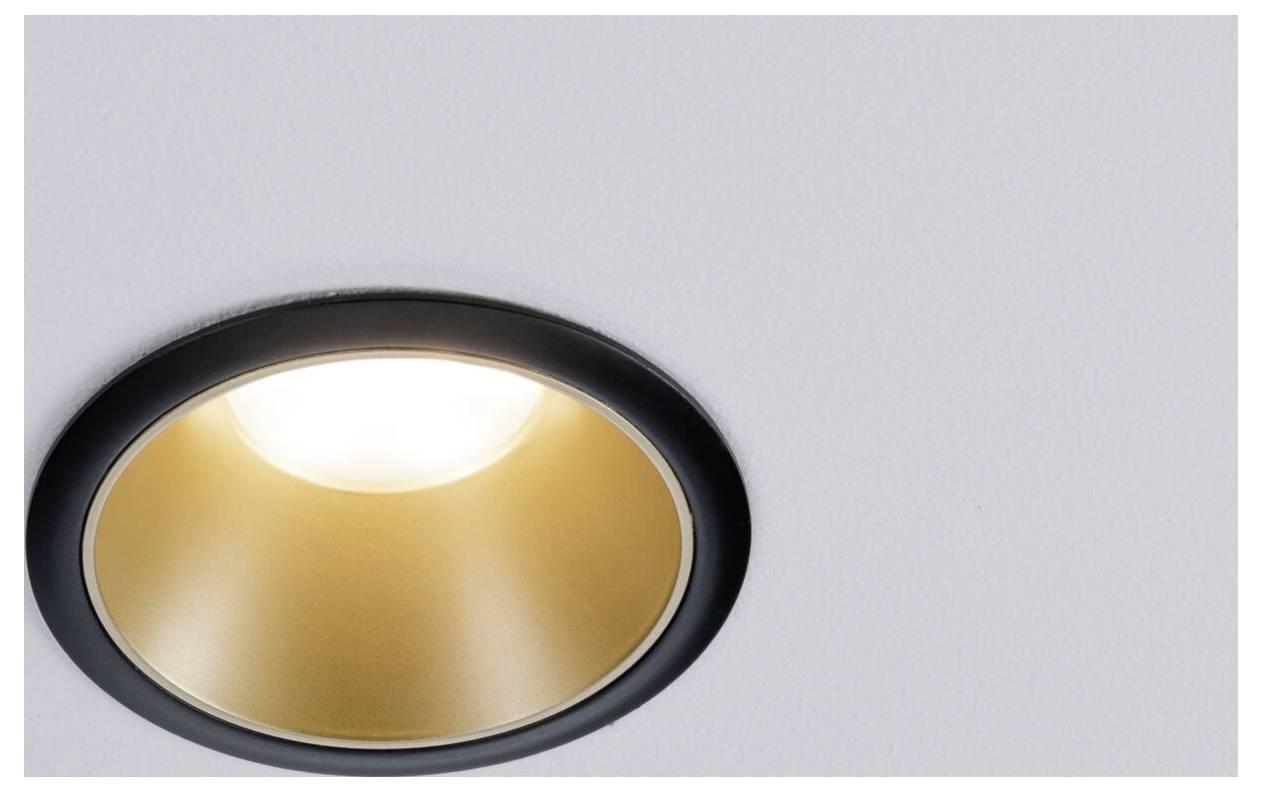 A built-in ceiling light with a black border and golden interior, radiating light.