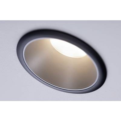 A recessed circular ceiling light emits warm light and illuminates the room.