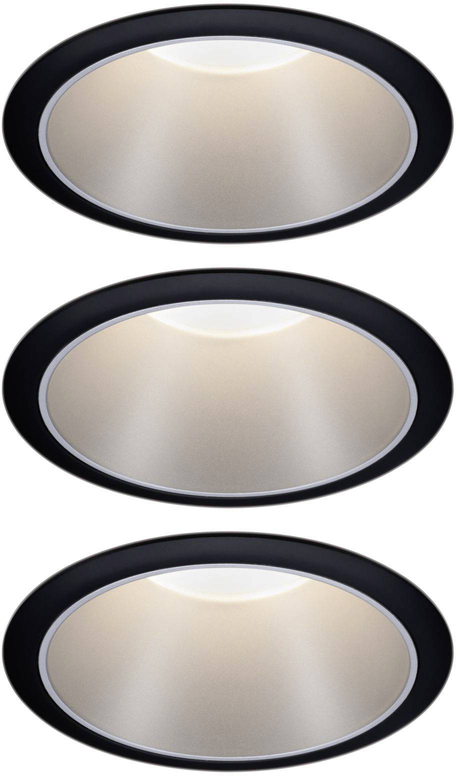 Three round recessed spotlights in black housings emit warm light.