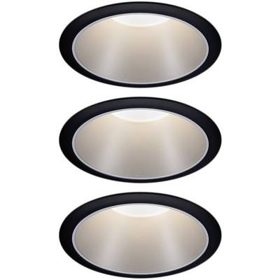 Three round recessed spotlights in black housings emit warm light.