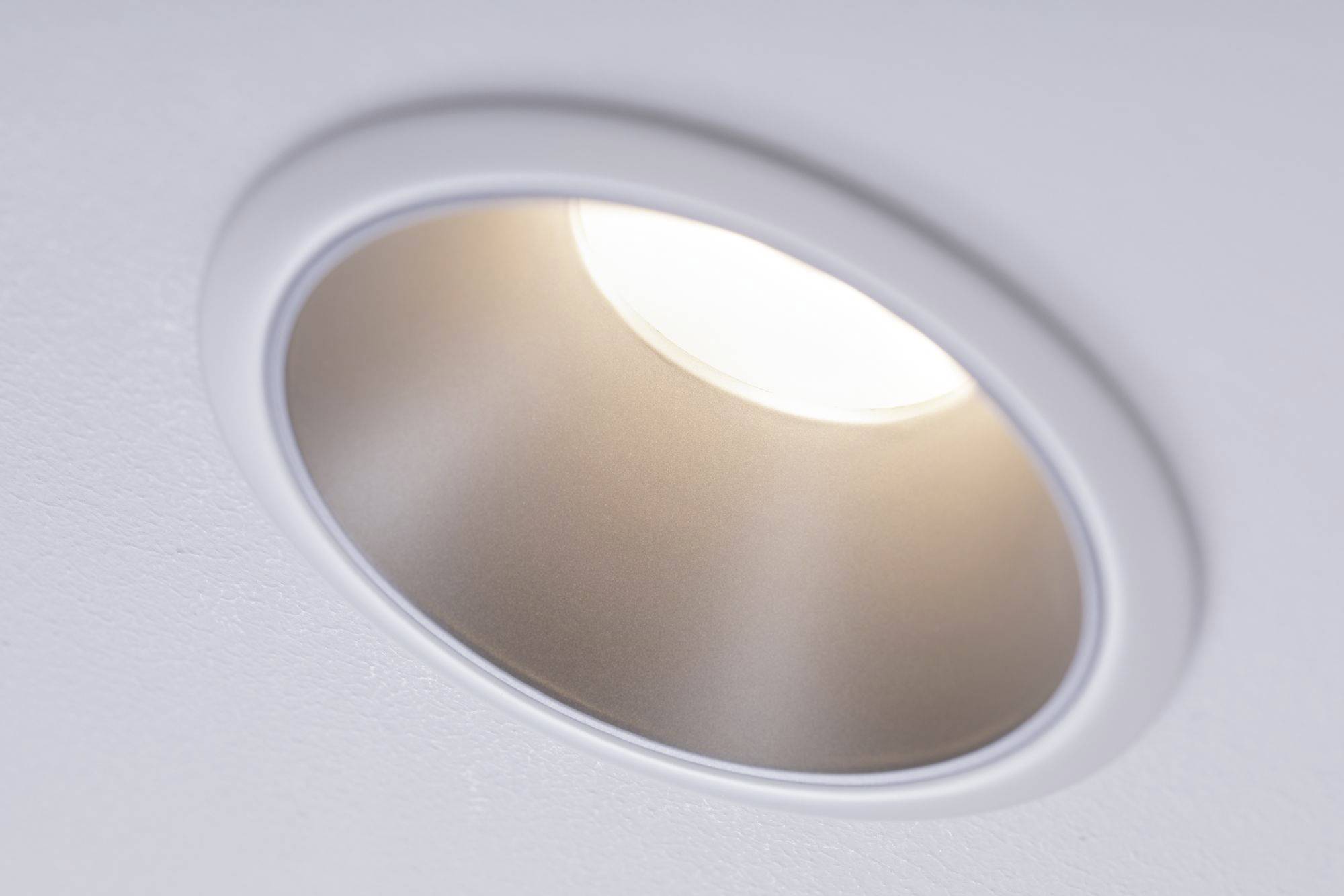 A round, recessed ceiling light shines brightly.